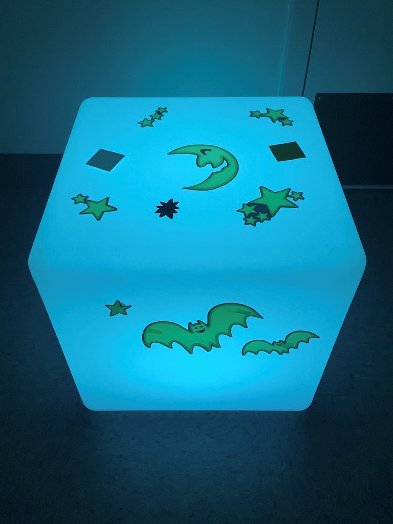 Photo shows the 3D cube lightbox with stars, moons, and bat stickers affixed to all faces.