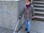 Photos shows a young student using a mobility cane to explore outdoors. 